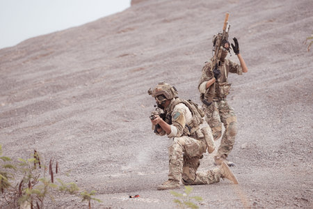 Soldiers in camouflage military uniforms carrying weapons, Reconnaissance missions in rugged...