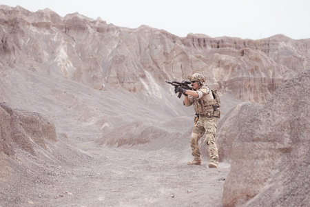 Soldiers in camouflage military uniforms carrying weapons, Reconnaissance missions in rugged...