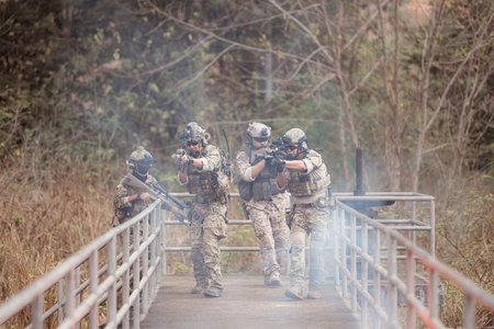 Soldiers in camouflage military uniforms carrying weapons, Reconnaissance missions in the tropical...