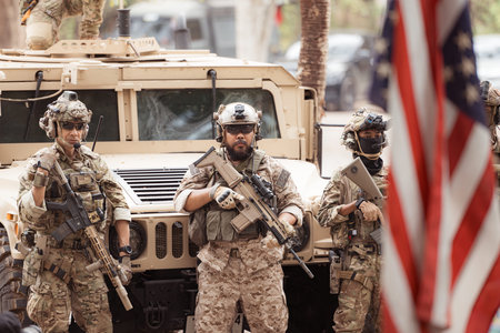 Portrait of soldiers in camouflage uniforms hold weapons in front of a military communication...