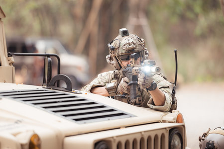 Soldiers in camouflage uniforms hold weapons ready to fire, By hiding on the side military...