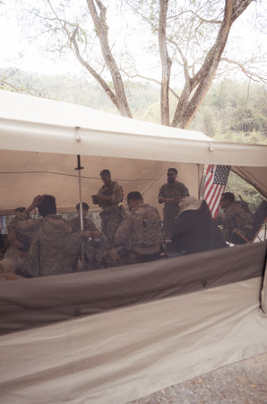 Group of soldiers in camouflage uniforms hold weapons in a field tent, Plan and prepare for combat training.の写真素材