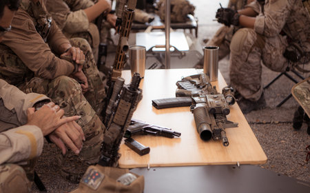 Group of soldiers in camouflage uniforms hold weapons in a field tent, Plan and prepare for combat training.の写真素材