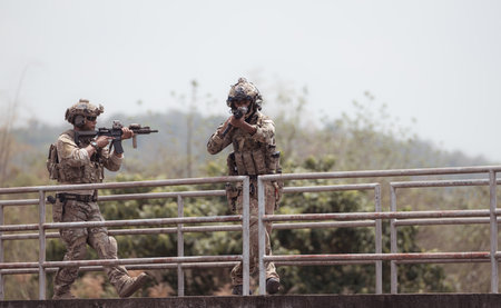 Soldiers in camouflage military uniforms carrying weapons, Reconnaissance missions in the tropical forest area, Assault infantry battle training.の写真素材