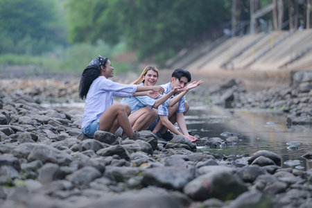 A group of friends are camping near a stream, but there is no water running.の写真素材