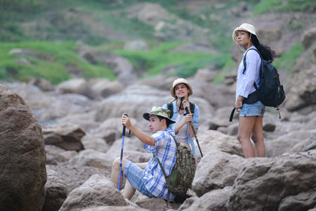 A group of friends going hiking in the streams of the tropical forest area.の写真素材