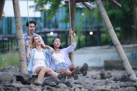 A group of friends are camping near a stream, but there is no water running.の写真素材