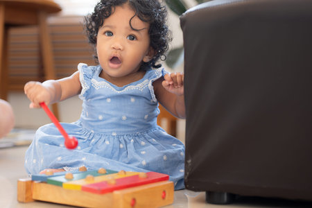 Child playing happily with toys in the living room of houseの写真素材