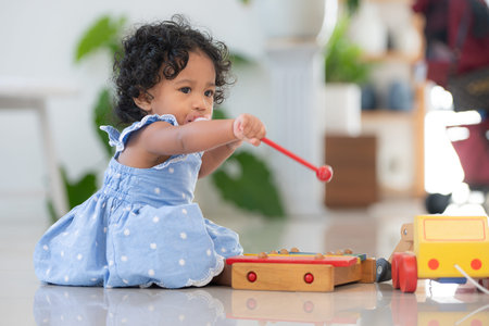 Child playing happily with toys in the living room of houseの写真素材