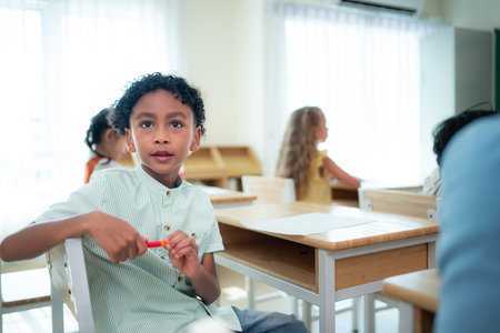 Teacher and students, Learn and study in a classroom of school where youngsters sit and listen attentively.の写真素材