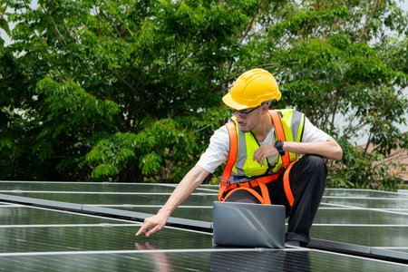 Technician inspects solar panel installation and test the operation of the panelの写真素材