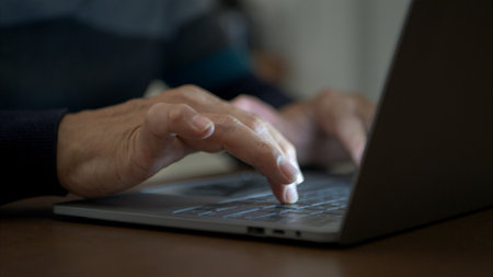 Senior businessman working from home and entering data on the computerの写真素材