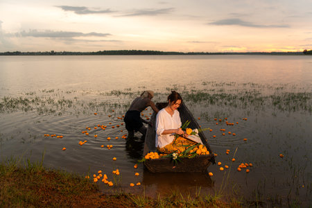 Young woman on a boat with yellow flowers in the lake during the sunset