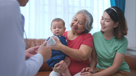A little child and his family visit the doctor for a routine health checkupの写真素材
