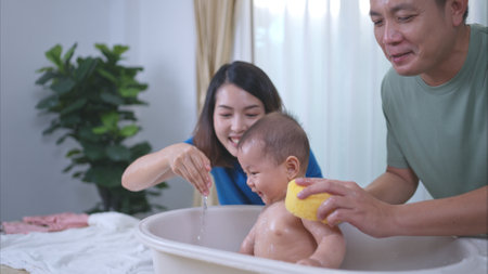 Parents bathe little child after ate mealの写真素材