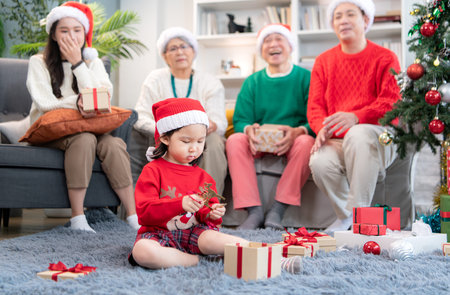 Little child with a joyful moment for a large family celebrating together at home during the...