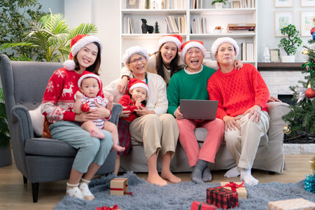 A joyful moment for a large family celebrating together at home during the Christmas seasonの写真素材