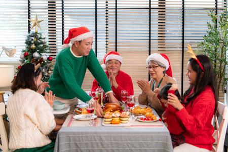 Family members gather to enjoy a meal together during the Christmas holiday at home