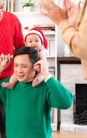 Little child with a joyful moment for a large family celebrating together at home during the...