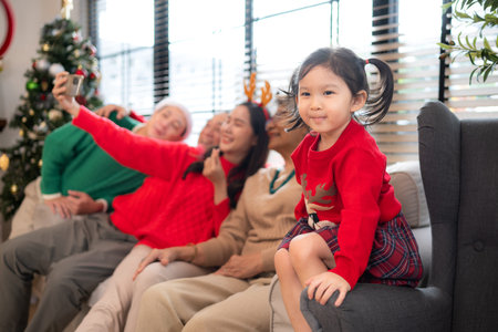 A joyful moment for a large family celebrating together at home during the Christmas seasonの写真素材