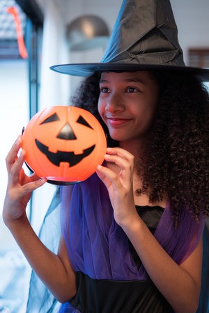 Children in ghost costumes are having fun trick-or-treating on Halloweenの写真素材