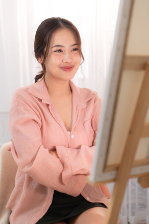 Asian young woman enjoying the happiness of paintingの写真素材