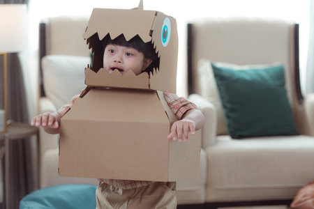 A special child with his favorite dinosaur figure, having fun in the living room of the houseの写真素材