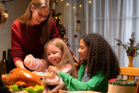 Grandfather, parents, and the teenage girls are all having dinner together at home on Christmas...