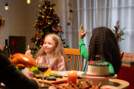 Grandfather, parents, and the teenage girls are all having dinner together at home on Christmas nightの写真素材