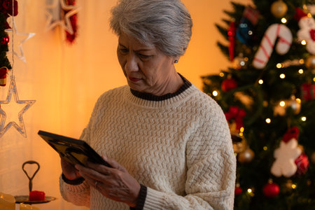Elderly woman and lonely moments in Christmas dayの写真素材