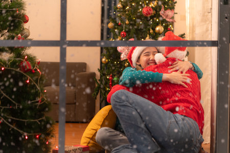 Couples give each other gifts on a snowy Christmas nightの写真素材