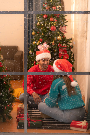 Couples give each other gifts on a snowy Christmas night