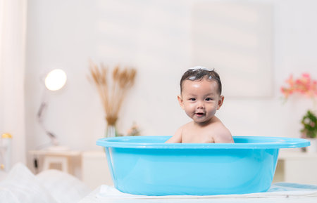 When mom gives the baby a bath, he enjoys itの写真素材