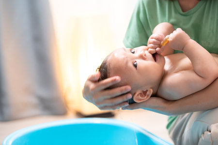 When mom gives the baby a bath, he enjoys itの写真素材