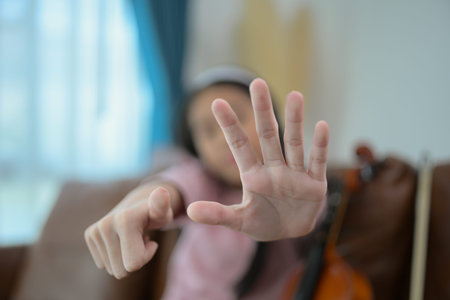A girl violinist plays and practices the violin at homeの写真素材