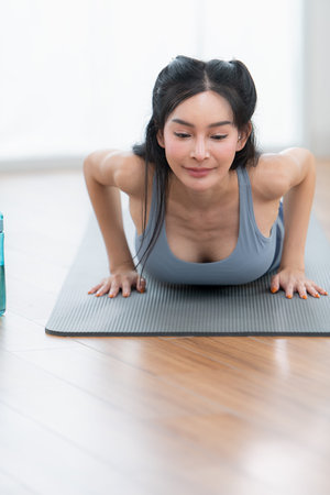 Asian young women doing yoga exercises during their holiday at home