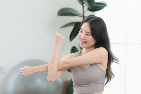 Asian young women doing yoga exercises during their holiday at homeの写真素材