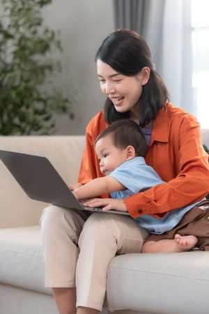 Mother and son play together after dad comes home from workの写真素材