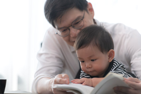 A business father and his duty to take care of his children while workingの写真素材