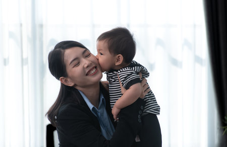 A business mother and his duty to take care of his children while workingの写真素材
