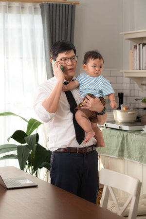 A business father take care children while workingの写真素材