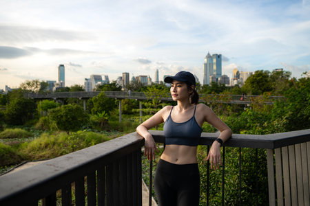 Young woman and exercise time in a city parkの写真素材