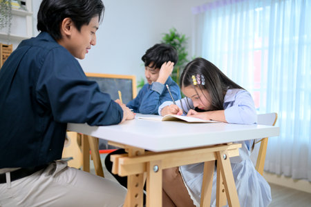 Small class, Teacher and pupils in the home classroom, reviewing lessons and offering homework adviceの写真素材