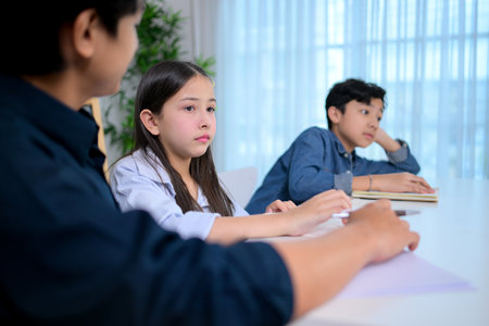 Small class, Teacher and pupils in the home classroom, reviewing lessons and offering homework adviceの写真素材