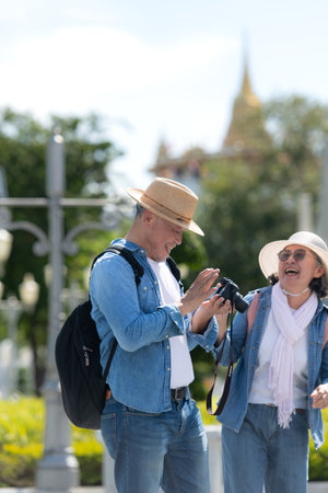 An elderly couple walks around the street in the old city of Bangkok, Thailand.の写真素材
