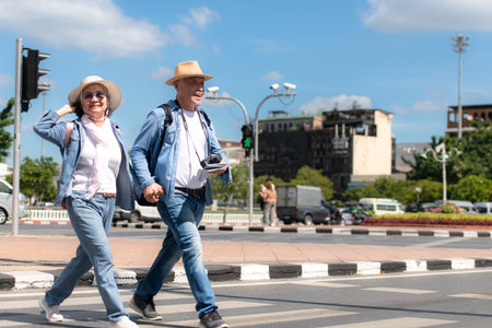 An elderly couple walks around the street in the old city of Bangkok, Thailand.の写真素材