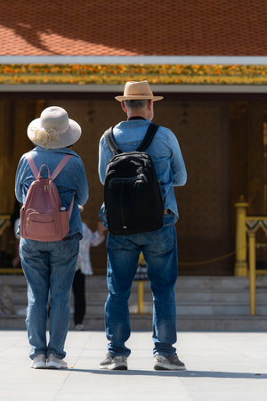 An elderly couple walks around the street in the old city of Bangkok, Thailand.の写真素材