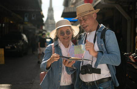 Elderly couples and their activities on the road at the end of the alley where there is a pagoda of Wat Arun, Thailandの写真素材
