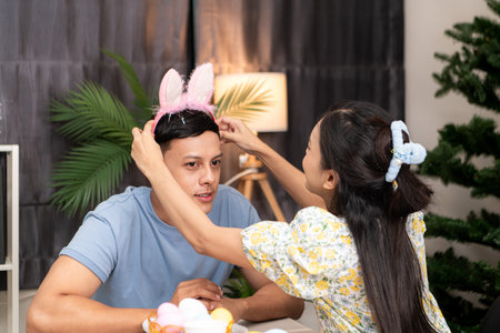A young couple is designing and painting Easter eggs