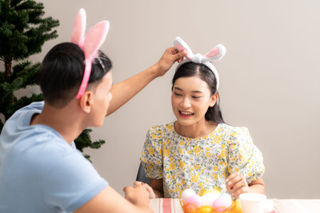 A young couple is designing and painting Easter eggs on Easter